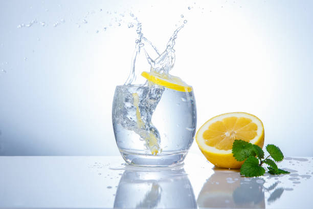 Measuring water in a kitchen jug beside fresh fruit